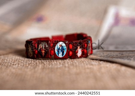 Christianity red wooden wrist decoration bracelet, with small pictures of Jesus saint maria and so on.