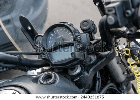 Close up of a modern motorbike dashboard and handlebars with rev-counter, gauges, displays and buttons Royalty-Free Stock Photo #2440251875