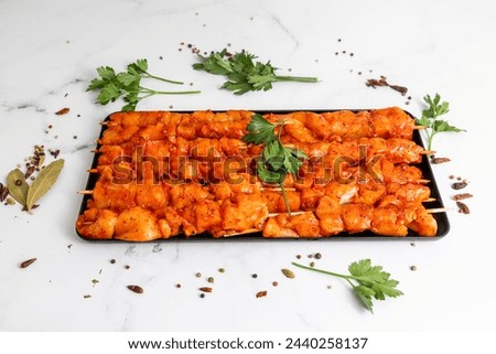 Chicken skewers marinated in spices. raw meat ready to be cooked Royalty-Free Stock Photo #2440258137