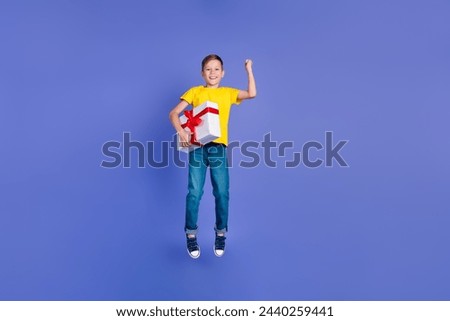 Photo of beautiful cheerful cute boy wear trendy yellow clothes celebrate birthday receiving gift isolated on violet color background