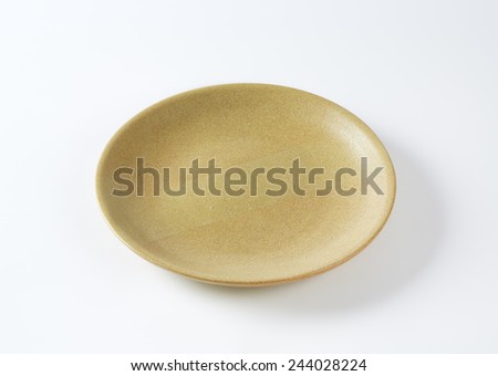 empty beige plate on white background