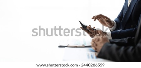Financial advisor is discussing statistical data analysis and financial planning. Businessman discuss analyzing data, charts and graph of business financial growth and planning investment strategies.