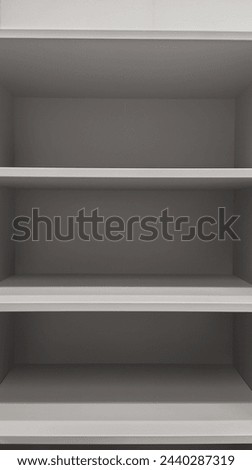 close up of empty white shelves, gray background, photorealistic, hyperrealism, high resolution photography 