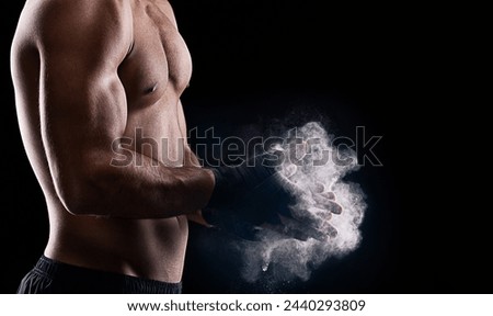 Powder, male boxer and hands in studio, dark and muscles for fitness isolated on black background. Chalk, dust, combat sports and exercise for man athlete, MMA and boxing for training or competition