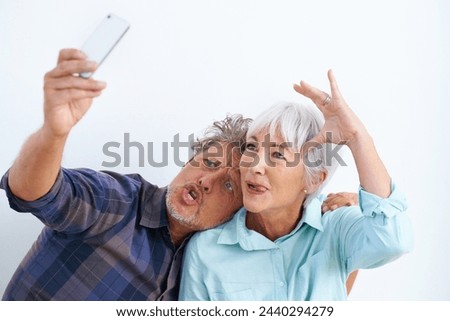 Old couple, funny face in selfie and crazy together for social media post, memory and love with fun on white background. Comic, silly or goofy with people in marriage, happy in picture and mobile app