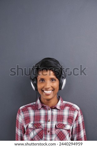 Headphone, woman and portrait for gadget, audiobook and sound for listen or hear for podcast. Young person and smile in studio for radio, streaming and waves for volume, loud and speaker for track