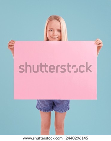 Child, portrait and poster mockup in studio as billboard presentation for placard on blue background, announcement or board. Female person, face and smile or information banner, contact us or paper