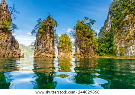 Beautiful mountains lake river sky and natural attractions in Ratchaprapha Dam at Khao Sok National Park, Surat Thani Province, Thailand. Royalty-Free Stock Photo #244029868