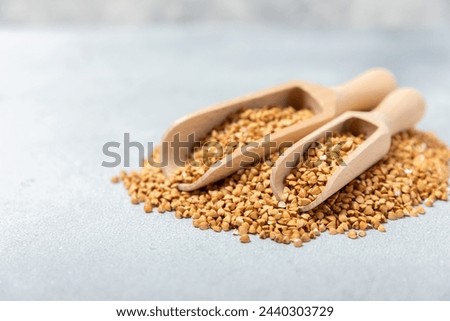 Green buckwheatin  on a wooden kitchen table.Superfood.Raw buckwheat porridge.Healthy vegan food concept, eco products, diet. Copy space.Organic food.weight loss and proper nutrition.