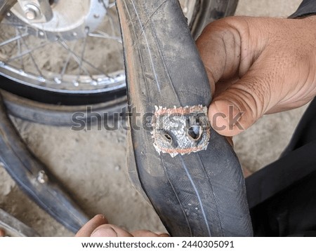Holes In Motorcycle Tire. Repairing Work Picture 
