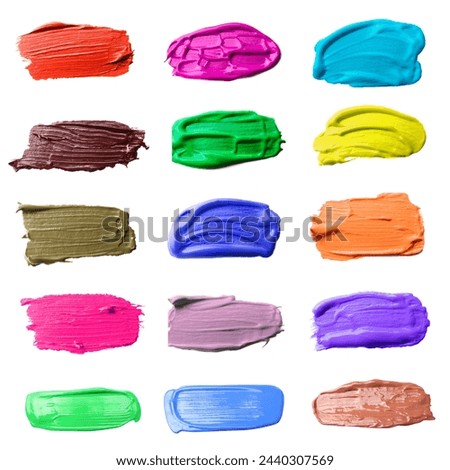 Paint strokes of different colors on white background, top view