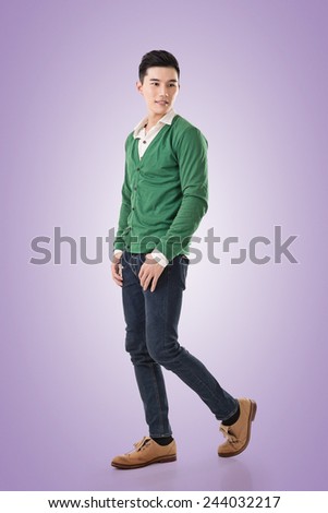 Attractive young Asian man, full length portrait isolated on white background.