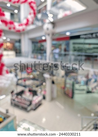 Defocused scene inside a modern shopping mall. Blurred background of commercial center
