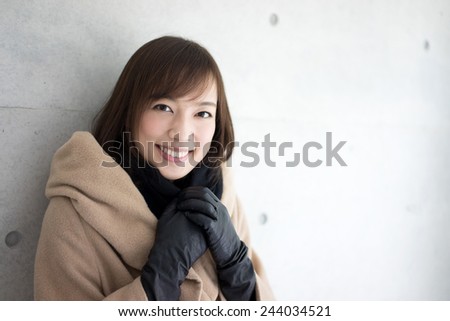 Woman dressed with wool coat and scarf 
