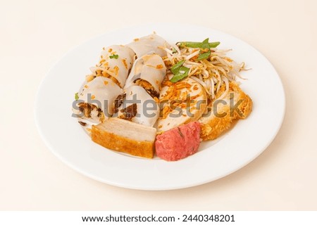 Banh Cuon, Vietnamese steamed rice rolls pancake with savory mixture of ground pork, Vietnamese food isolated on white background, close-up Royalty-Free Stock Photo #2440348201