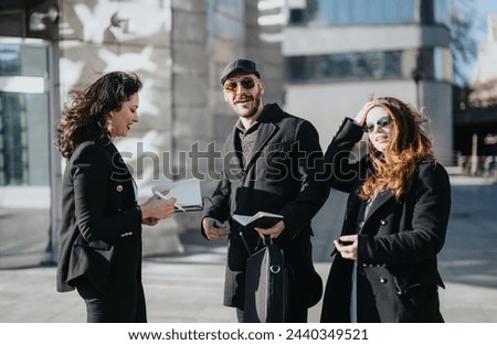 A group of young business professionals are engaged in a lively discussion in an urban setting, showcasing teamwork and entrepreneurship. Royalty-Free Stock Photo #2440349521