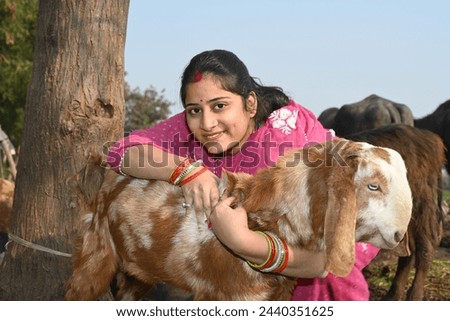 Portrait of an Indian people giving food to goat in village