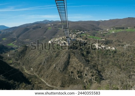 Panoramic view of Sellano's Tibetan bridge, adrenaline and excitement in the heart of Umbria region, Italy Royalty-Free Stock Photo #2440355583