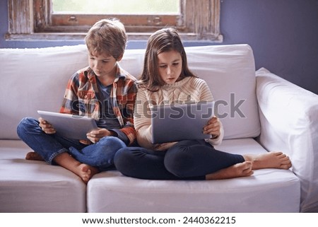 Young boy, girl and tablet for gaming on sofa together, technology and online streaming for bonding at home. Digital .world, internet with kids or siblings in living room, gamer app and entertainment
