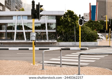 Road, traffic light and sign for pedestrian by crosswalk with mistake for humor, joke and comic grammar in city. Asphalt, error and funny signage with board, language and design with warning in town Royalty-Free Stock Photo #2440362257