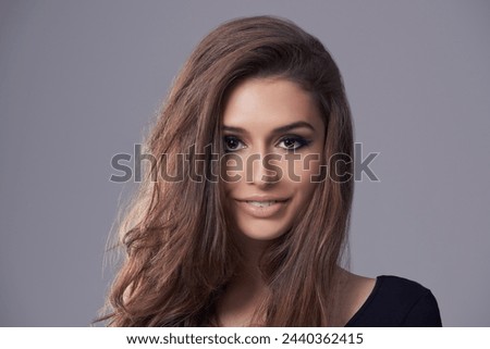 Haircare, portrait and woman in studio for hairstyle, treatment and glow on isolated grey background. Shampoo, smile and face of female model with natural cosmetics, salon and volume in mockup space