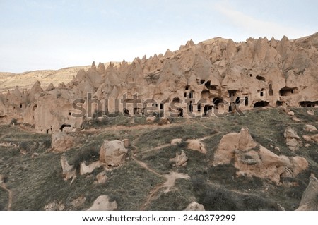 Zelve open air museum, one of the natural beauties of the Cappadocia region. The old residential area of Zelve Valley. Cave houses. Fairy chimneys and volcanic formations. Royalty-Free Stock Photo #2440379299