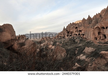 Zelve open air museum, one of the natural beauties of the Cappadocia region. The old residential area of Zelve Valley. Cave houses. Fairy chimneys and volcanic formations. Royalty-Free Stock Photo #2440379301