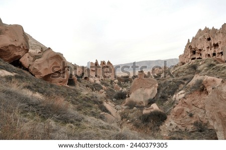 Zelve open air museum, one of the natural beauties of the Cappadocia region. The old residential area of Zelve Valley. Cave houses. Fairy chimneys and volcanic formations. Royalty-Free Stock Photo #2440379305