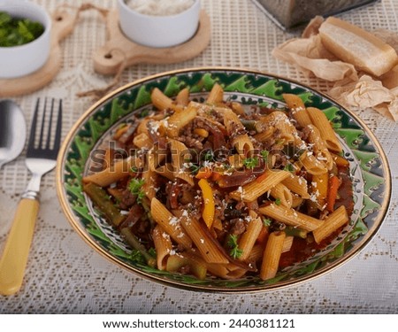 Pasta dish with minced beef and vegetables in a rich sauce.