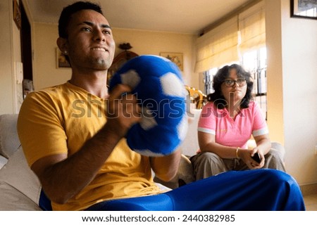 Siblings whatching soccer Match on tv at home