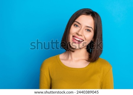 Photo of pretty charming lady dressed shirt smiling tongue licking lips empty space isolated blue color background
