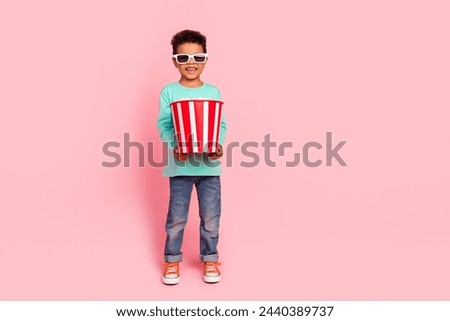 Full body photo of cute little boy 3d glasses hold popcorn bucket dressed stylish cyan clothes isolated on pink color background