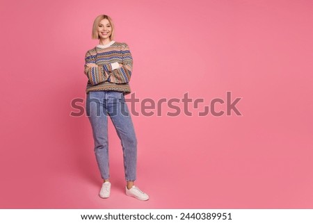 Full length photo of positive good mood woman dressed print sweater denim pants holding palms crossed isolated on pink color background
