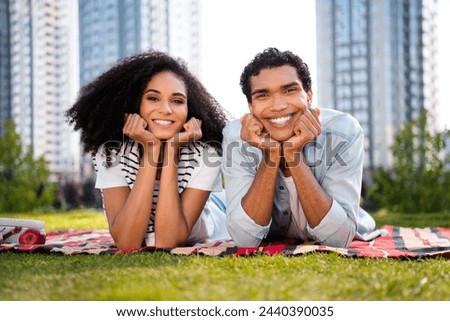 Photo of two positive nice people lying comfy blanket lawn toothy smile spend free time fresh air outside