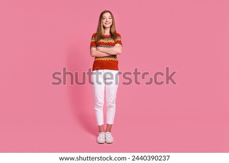 Full size portrait of satisfied glad lovely girl folded hands posing empty space isolated on pink color background Royalty-Free Stock Photo #2440390237