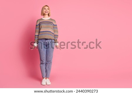 Full size photo of lovely nice woman wear ornament pullover denim pants look at offer empty space isolated on pink color background