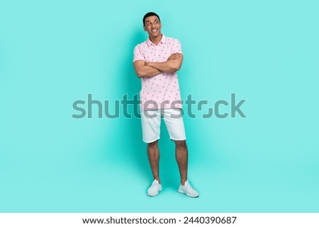 Full size photo of good mood guy dressed casual polo white shorts palms folded look at offer empty space isolated on teal color background