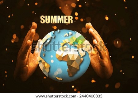 A person is holding a globe with the word "summer" written on it. Concept of warmth and happiness associated with the season