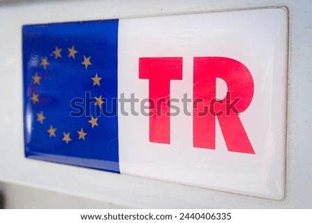 Turkey-EU Relations: Symbolic EU Flag and TR Emblem. Royalty-Free Stock Photo #2440406335