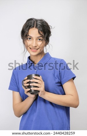 Young beautiful Pakistani Girl enjoying coffee, Closeup of a Pakistani girl holding a black coffee mug