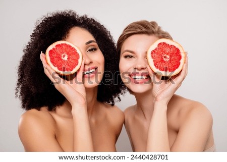 Photo of two girls cove rface with slice orange fruit over pastel color background