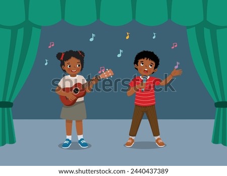 Happy little African kids singing and playing guitar performing on the stage