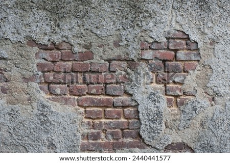 Texture: Brick wall. The plaster is crumbling very badly. Royalty-Free Stock Photo #2440441577