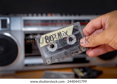 Cassette tape with stereo in the background