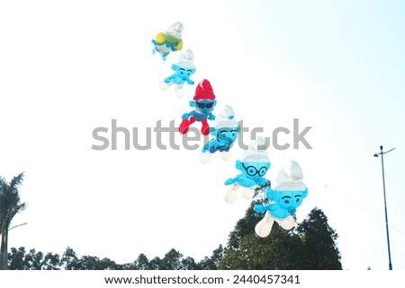 Colorful kites flying in the clear blue sky in summer.
