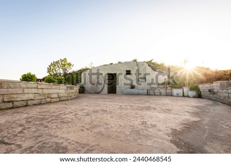 Empty tomb sepulcher with the stone rolled away from the open door Royalty-Free Stock Photo #2440468545
