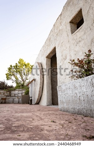 Empty tomb sepulcher with the stone rolled away from the open door vertical Royalty-Free Stock Photo #2440468949