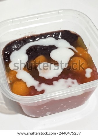 The picture was taken on March 22, 2024. It's an Indonesian traditional dessert called Takjil. It's a mix of condiments like sweet potato ball, black glutinous rice, pearl sago, with coconut milk