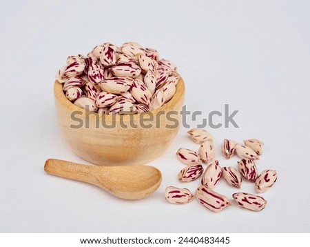 Several tiger peanuts in a wooden cup and wooden spoon And there were tiger striped peanuts lying on a white background. They were tiger striped peanuts that I grew myself naturally. Royalty-Free Stock Photo #2440483445