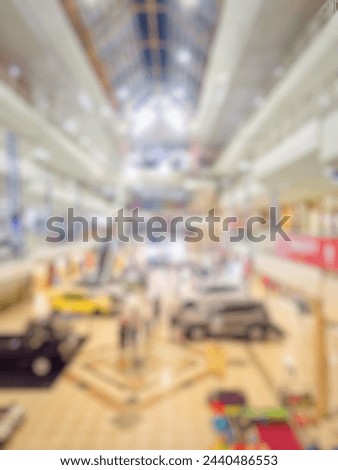 abstract blur background of interior in shopping mall or shopping center. Lombok, Indonesia. Bokeh vintage tone effect image of mall hall with car trade show